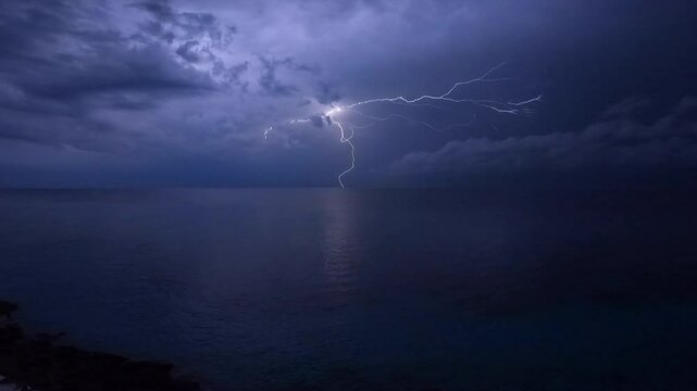 Explosive Dramatic Nighttime Lightning Storm exploding lightning bolts flashing over the ocean near the Carribbean Sea and the Gulf of Mexico