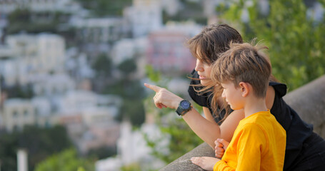 Young mother with little son admiring panorama of Positano on Amalfi