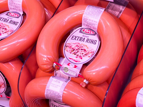 Packaged extra ring sausages with labels in store display