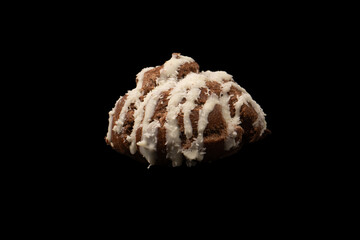 Profiteroles with coconut cream on a black background.