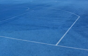 Blue sports field coating with white lines