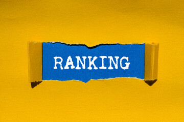 Ranking message written on ripped torn yellow paper on blue background. Conceptual ranking symbol....