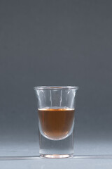 small shot glass with homemade alcohol tincture, liquor, cognac, brandy or whiskey