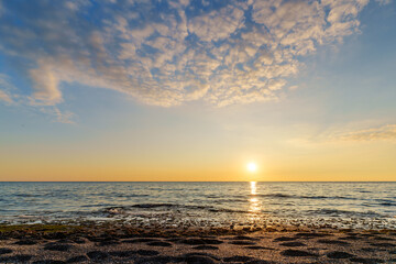 Tranquil Ocean Sunset With Reflective Waves and Soft Colorful Sky..