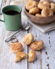 Samanta, typical brazilian sugar covered biscuit with coffee over wooden table