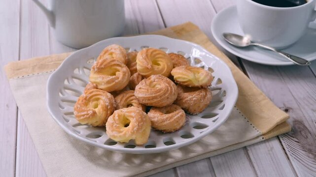 Hand putting Samantas on the table, typical brazilian sugar covered biscuit