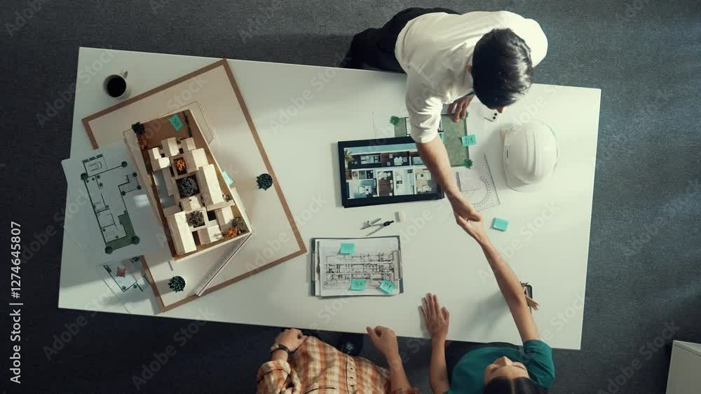 Poster top view of architect engineer working together and shaking hand cooperative team while making contr