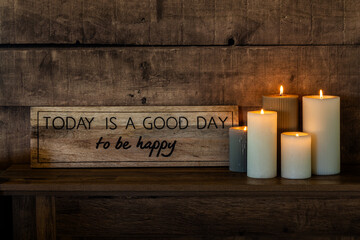 Motivational Sign and Candles on Rustic Wooden Shelf