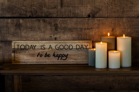 Motivational Sign and Candles on Rustic Wooden Shelf