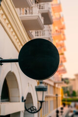 oval blank billboard of a store and restaurant isolated on black