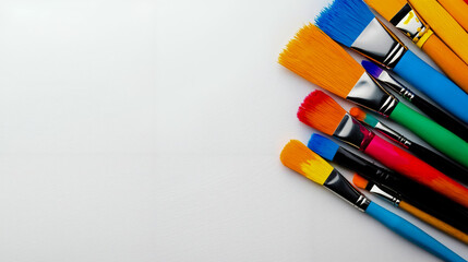 Fototapeta premium A bunch of paint brushes sitting on top of a white surface
