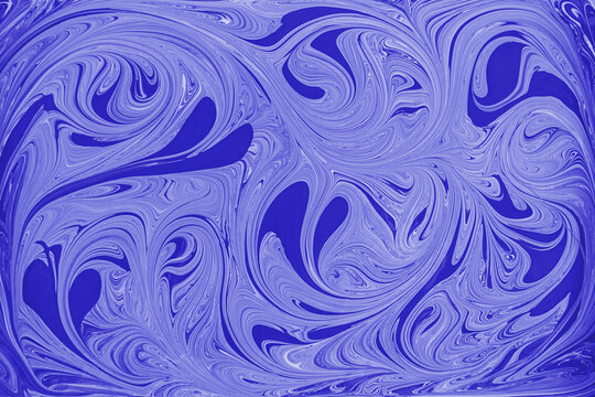 Blue and white acrylic paint swirls create abstract floral pattern