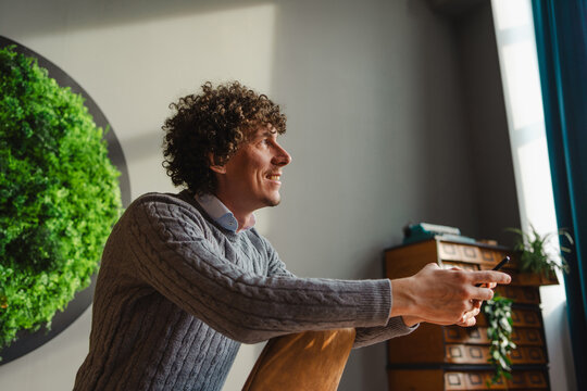 Young Man with Curly Hair Embracing Ecology and Sustainability