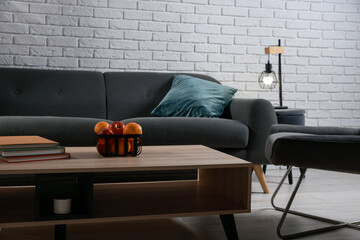 Comfortable sofa, armchair and coffee table in living room. Interior design