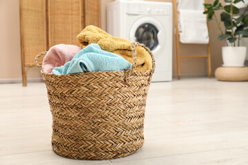 Wicker basket full of laundry in bathroom