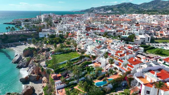 drone shot of Nerja, resort in southern Spain on the Mediterranean coast in Malaga, Nerja seaside town in Spain, luxury summer tourist destination 