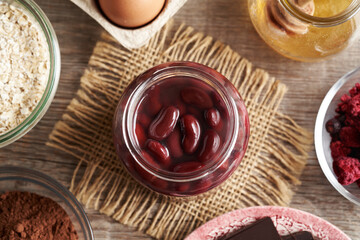Ingredients for baking gluten-free brownies - red kidney beans in a jar, oat flakes, eggs, cocoa and honey