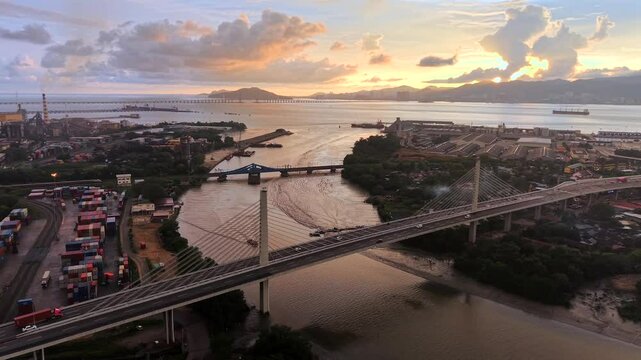 Butterworth, Penang, Malaysia aerial drone video at sunset of traffic on bridge over the Prai River at sunset looking towards Penang Island 