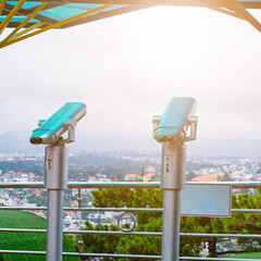 image of coin operated binoculars viewer in front of the sea landscape. vintage filtered