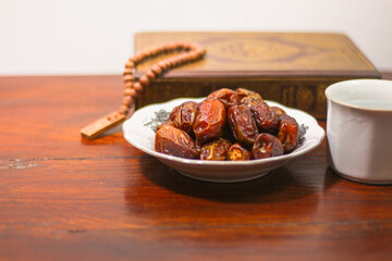 Dates and Muslim prayer beads, on a Wooden Table, Ramadan or Islamic Feast