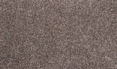 Ground poppy seeds background and texture, macro