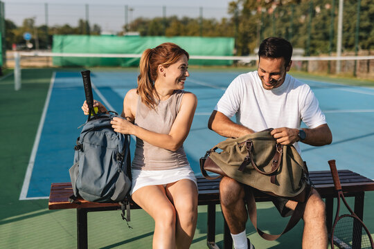 Young couple playing tennis outdoors enjoying a fun summer game