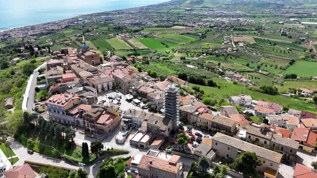Aerial drone view of Montepagano hill with buildings in the province of Teramo in Italy and the Adriatic Sea.
