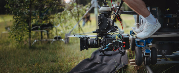 Professional cinema and video camera on the set. Shooting shift, lighting fixtures, shooting equipment and the team.