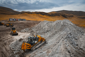 Bulldozer is doing its job at gypsum mining quarry