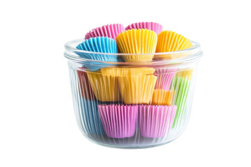 A vibrant assortment of colorful baking cups arranged neatly in a glass jar on a clean surface isolated on transparent background
