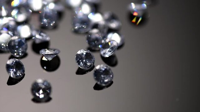 Diamonds, gems rotating on black background, crystals, beautiful shining brilliants sparkling with colorful caustics, rainbow lights. Moissanite. Zirconia. Diamonds sparkle and shimmer on black 