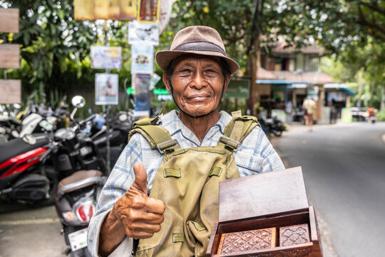 Balinese local vendor giving a thumbs up with handcrafted goods