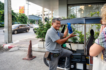 Thai tuk tuk driver interacts with anonymous tourists in Chiang Rai