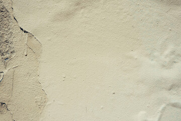 Abstract grunge wall background. Old plastered wall with many cracks. Grungy texture with deep pattern on yellow painted wall