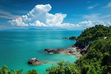 Fototapeta premium Tropical Ocean Meets Lush Cliffside with Distant Islands, Summer Vacation Spot.