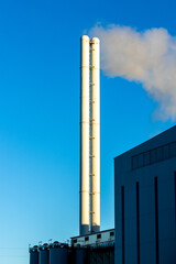 Industrial Chimney Stacks Emit Smoke Or Steam From Production