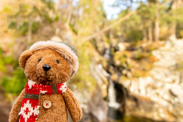 A Small Scottish Bear Sits Proud On The Wall Of A Bridge