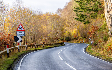 A Scottish Highland Road Taking Vehicles Through The Most Stunning Scenery