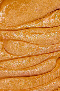 Close-up texture of smooth peanut butter
