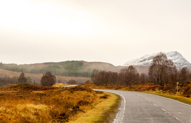 A Scottish Highland Road Taking Vehicles Through The Most Stunning Scenery