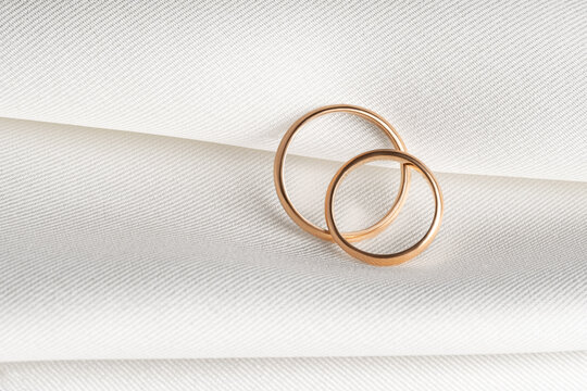 Wedding rings on textured fabric
