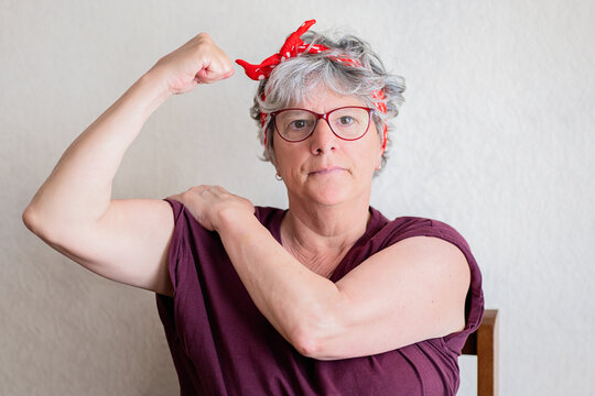 Confident Senior Woman Flexing Muscle in Empowerment Pose