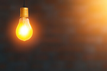 A light bulb is lit up and hanging from a wire