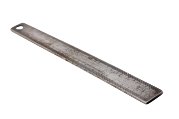 A close-up view of a weathered metal ruler on a white background showcasing its detailed markings isolated on transparent background