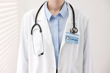 Doctor with badge in clinic, closeup view