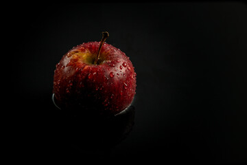 red apple on black background
