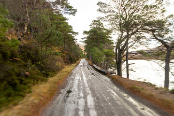 A Scottish Highland Road Taking Vehicles Through The Most Stunning Scenery
