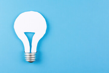 A white paper light bulb is drawn on a blue background