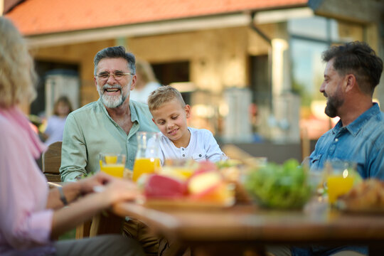 Happy multi generation family having lunch together on a sunny day