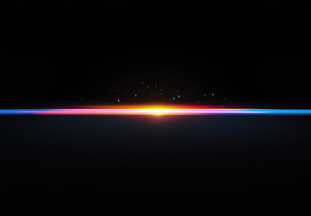 Fototapeta premium Abstract colorful light streak across a dark background, creating a vibrant horizontal line with glowing particles.